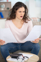 shocked young woman reading documents