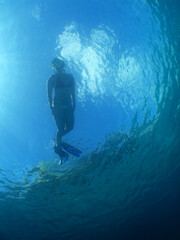 a woman snorkeling in the crystal clear waters