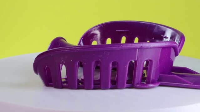 Rotating purple impression tray in dentistry for taking an impression of the dental jaw. Orthopedic dentistry. Manufacturing of dental crowns and dentures based on jaw impressions, close-up