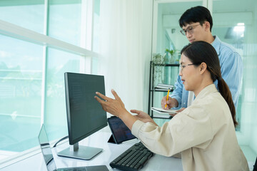 Obraz na płótnie Canvas IT programmers working together at office desk.
