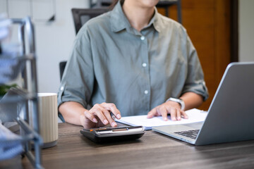 Woman casually working at home office.