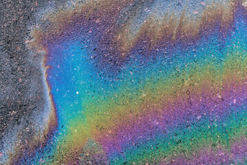 Gasoline pollution, oil, rainbow gasoline leak in the form of a glow on the sidewalk