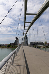 3 state bridge over the Rhine between Germany and France with a view of the Huningue skyline