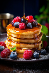 Breakfast Delight: Fluffy Pancakes with a Crown of Berries and Drizzles of Maple Syrup