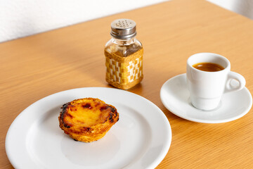 Indulge in a Portuguese delight: a creamy pastel de nata paired perfectly with a rich espresso....