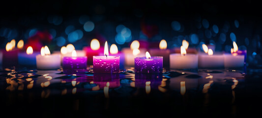 Candles with blue and purple flames, dark background, bokeh, Romantic background, Christmas or New Year composition with burning candles in small glass candlesticks, festive evening