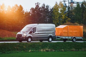A Car and a Rental Trailer on a Curvy Road. A Smart Way to Move Your Stuff. Transporting Cargo with a Car and a Trailer. A Convenient and Cost-Effective Solution.