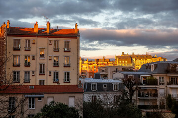 Buildings and cloudy sky at dusk, Montrouge, France.