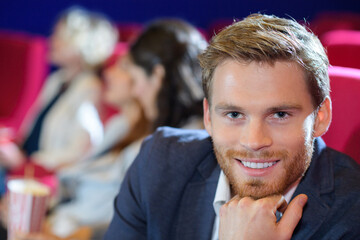 happy man watching movie in theatre