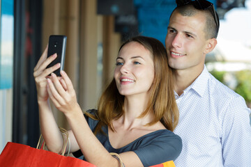 happy couple taking selfie with smartphone