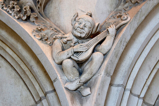 Jacques Coeur Palace, Bourges, France. Sculpture in the banqueting hall : Goblin playing a zither