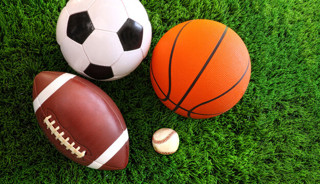 Assortment of sport balls on grass © Flavia