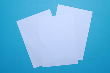 White blank flyer poster, brochure mockup on blue background