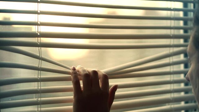 At sunrise, opening window blinds