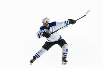 Man, ice hockey player in motion during game with stick, training, playing against white studio...