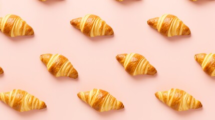 a pattern of croissants on a pink background - obrazy, fototapety, plakaty