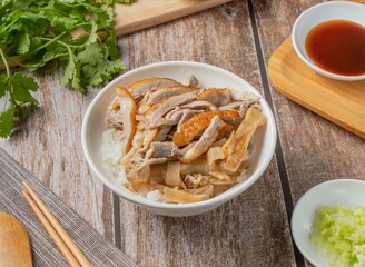 Duck Meat Rice with chilli sauce, noodles, spoon and chopsticks served in dish isolated on napkin top view of hong kong food