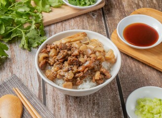Pork rice with chilli sauce, noodles, spoon and chopsticks served in dish isolated on napkin top view of hong kong food