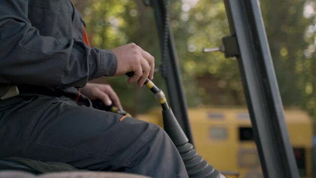 close-up of the crane operator's hands on the control levers of the construction crane
spectacular footage of a crane operator at work shot with a moving camera