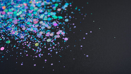 Multicolored glitter on black background