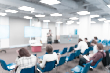 Businesswoman leading a master class, seminar or lesson in the office. Blur. High quality photo