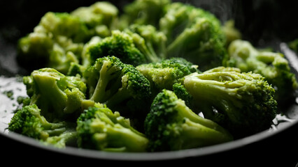 Fresh broccoli frying on a pan. Healthy food, vegetarian cuisine