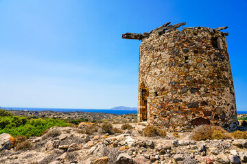 Landscape on the Greek island of Kos with a ruin of an old windmill.
