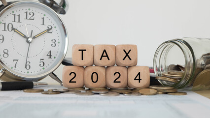 Tax wooden letter and 2024 number on wooden block.Pay tax  Income Statement. paying the tax rate....