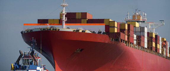 MARITIME TRANSPORT - A container ship sails with cargo to the sea port