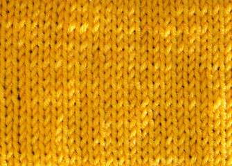 The texture of the satin stitch pattern is knitted with yellow wool yarn.