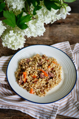 Fototapeta na wymiar Barley porridge with stewed meat and carrots.