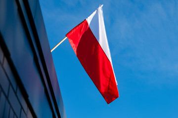 Polish flag against a blue sky background
