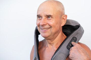 senior, 65s Caucasian man with uses portable electric massager, therapeutic relaxation of...