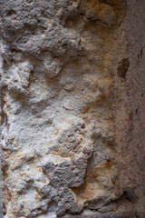 Fragment of old stone wall. Rough textured surface