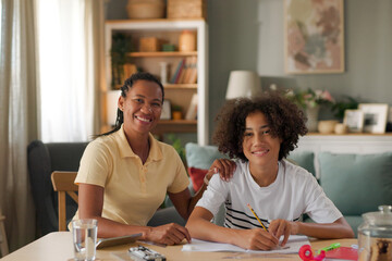 Mom helping a teenage son study for exam at home