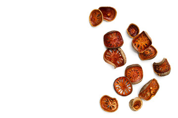 Dried bael fruit slices on white background.
