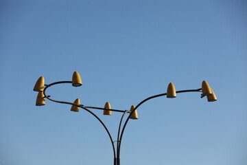 Original yellow street lamp with blue sky background
