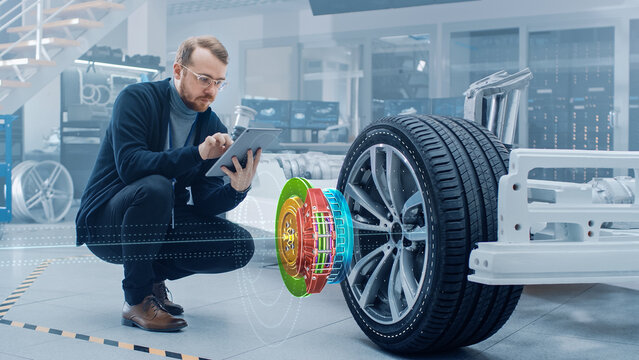 Automotive Engineer Working on Electric Car Chassis, Using Augmented Reality Headset with 3D VFX Application for Development of Regenerative Braking System on a Concept Transport Vehicle.