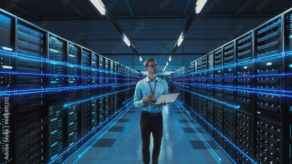 Poster futuristic concept: data center chief technology officer holding laptop, standing in warehouse, info