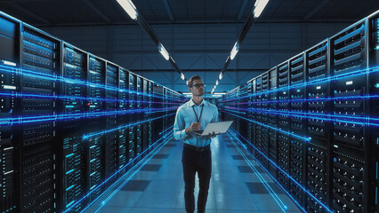 Futuristic Concept: Data Center Chief Technology Officer Holding Laptop, Standing In Warehouse, Information Digitalization Lines Streaming Through Servers. SAAS, Cloud Computing, Web Service - 682811212