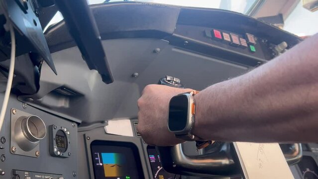 Inflight emergency (simulated, thankfully) situation in a modern jet cabin with a fire warning lights flashing while pilot is flying. Close up view, low angle, Captain side.