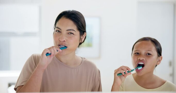 Happy mother, girl and brushing teeth in bathroom for dental care, hygiene or morning routine together at home. Mom and little child or kid smile in cleaning oral, gum or mouth for tooth whitening