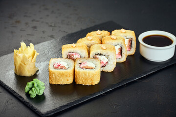 Tempura hot sushi rolls with salmon on dark background. Sushi menu. Japanese food.
