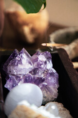 amethyst geode in a wooden box with quartz and selenite with incense stick