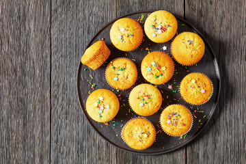 sweet lemon muffins on black plate, top view