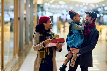 Carefree family has fun while shopping at mall for Christmas.