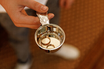 Wedding rings before consecration with holy water