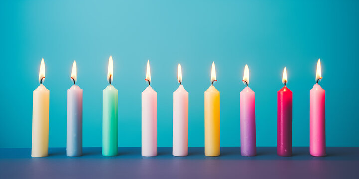 13 burning colorful candles against a blue background - birthday, anniversary or celebration theme