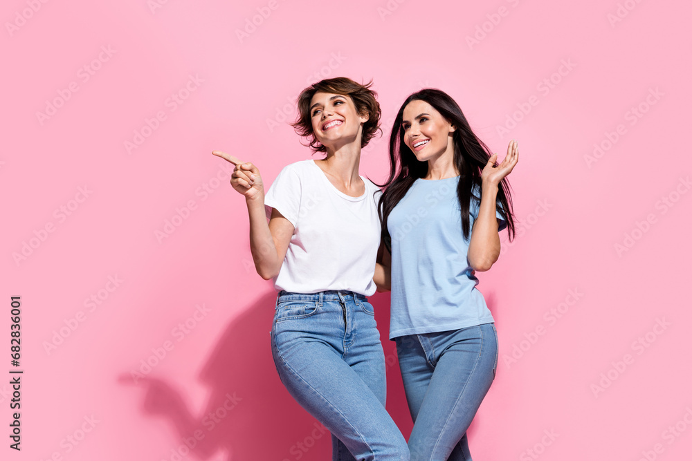 Canvas Prints Photo of two fancy charming girls lesbians together party point finger empty space interested offer isolated on pink color background