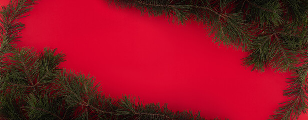 Christmas border with xmas tree on red background. Winter holiday. Happy New Year. Space for text....